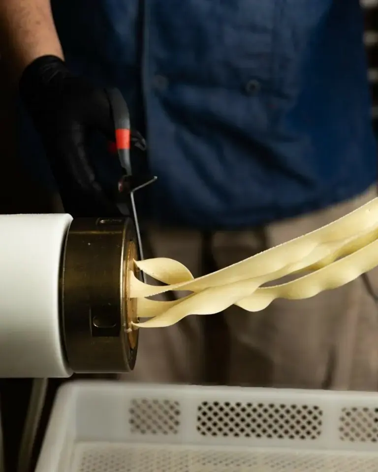 Pasta being rolled by hand in one of the group's kitchens